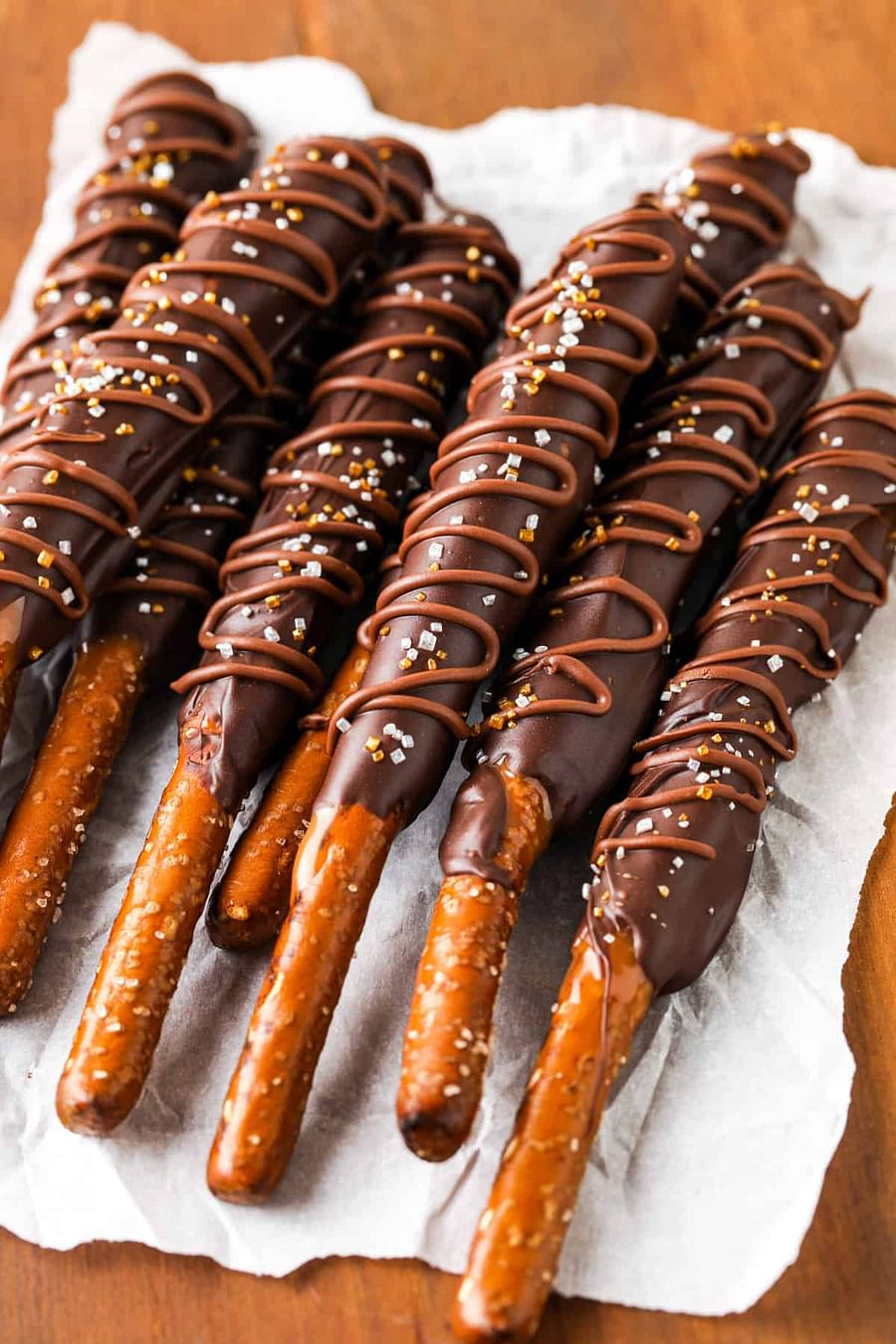Delicious homemade chocolate covered pretzel rods piled up